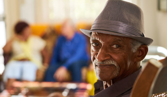 elderly man enjoying visiting with his family