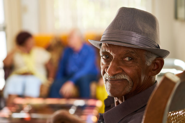 elderly man enjoying visiting with his family