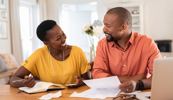 adult couple reviewing bills and open enrollment materials