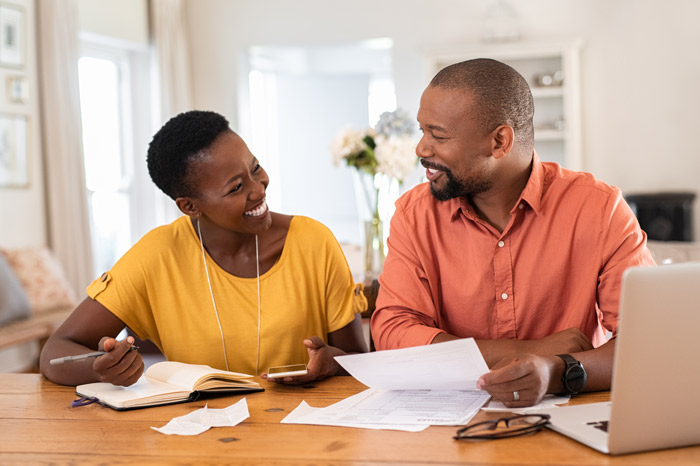 adult couple reviewing bills and open enrollment materials